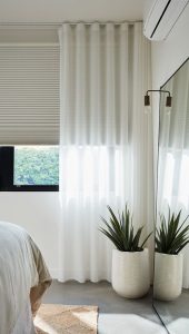 Combine cellular shades with a curtain for a layered effect