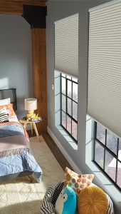 Honeycomb shades in a bedroom gives privacy