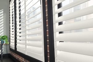 White shutters against dark window frames