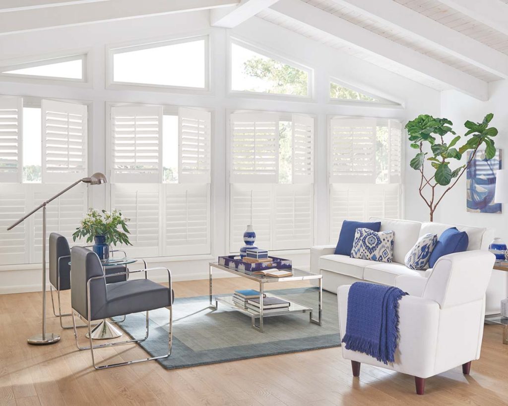 White window shutters in a bright livingroom with white furniture